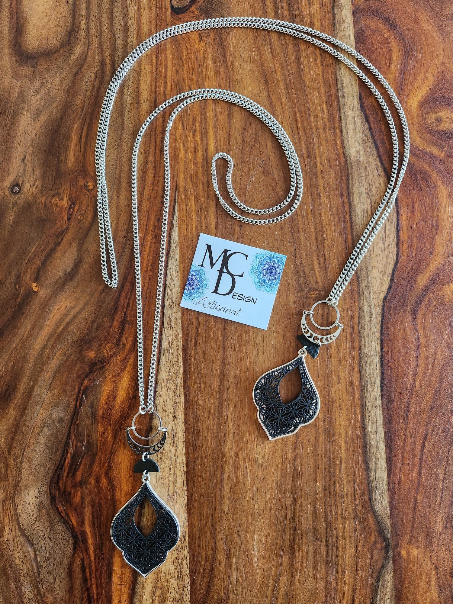 Superbe collier inox avec croissant de lune et breloques noires.